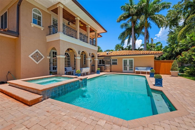 view of pool with a fenced in pool, a ceiling fan, an in ground hot tub, french doors, and a patio area