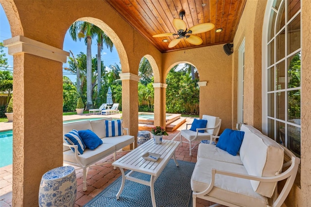 view of patio / terrace with an outdoor hangout area, an outdoor pool, and a ceiling fan