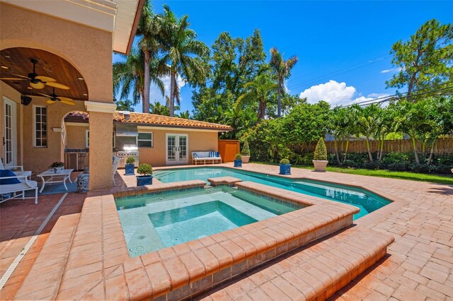 view of pool with french doors, a ceiling fan, a patio area, an in ground hot tub, and fence private yard