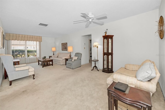 carpeted living room featuring ceiling fan