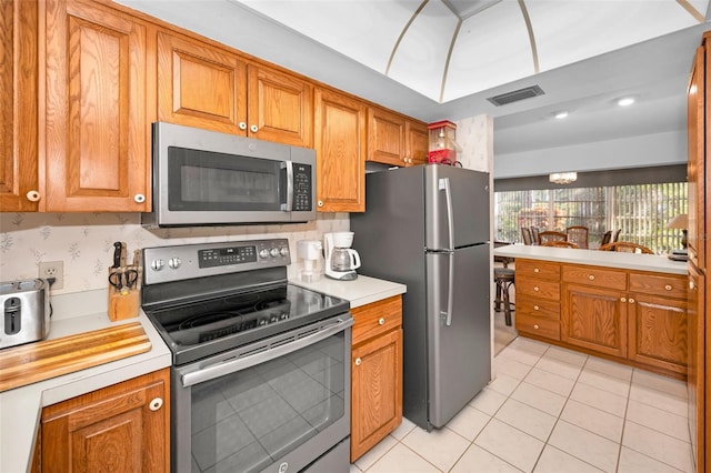 kitchen with light tile patterned floors and appliances with stainless steel finishes