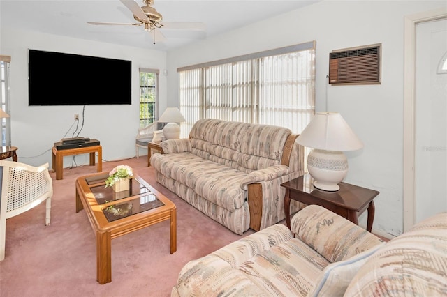 living room with a wall unit AC, ceiling fan, and carpet flooring