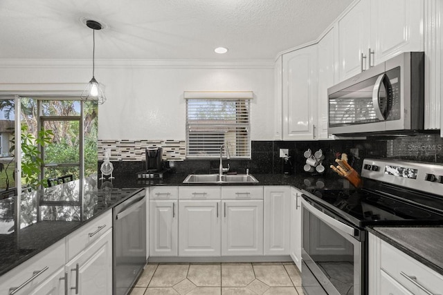 kitchen with white cabinets, sink, stainless steel appliances, and light tile patterned flooring