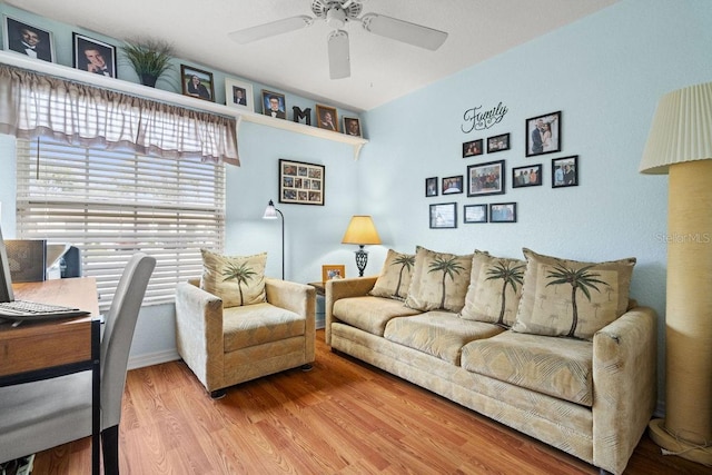 living room with ceiling fan and wood-type flooring