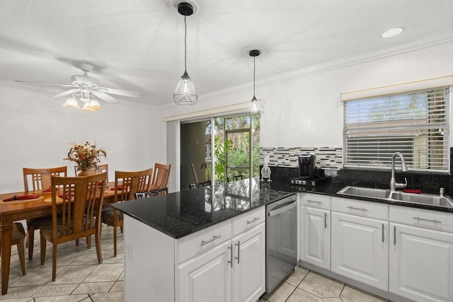 kitchen featuring pendant lighting, stainless steel dishwasher, sink, crown molding, and white cabinetry