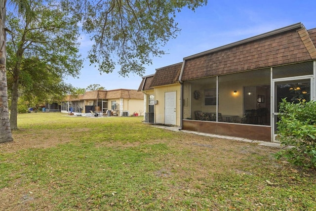 rear view of property featuring a yard