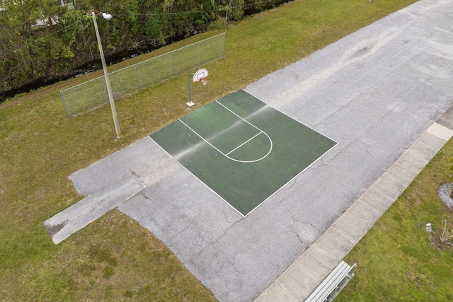 view of basketball court featuring a yard