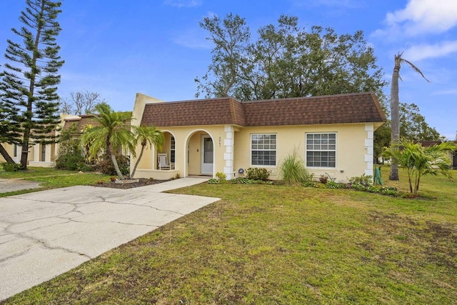 mediterranean / spanish home with a front yard