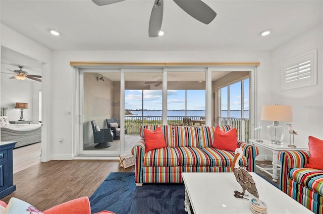 living room featuring a water view and wood-type flooring