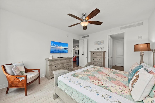 bedroom with ceiling fan and light hardwood / wood-style floors