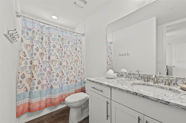 bathroom featuring toilet and vanity