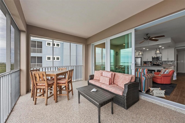 sunroom featuring ceiling fan and a wealth of natural light