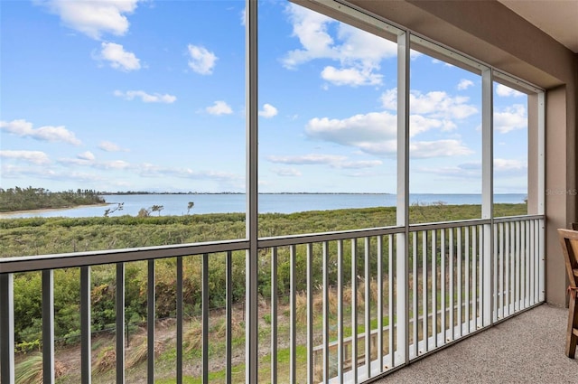 unfurnished sunroom with a water view