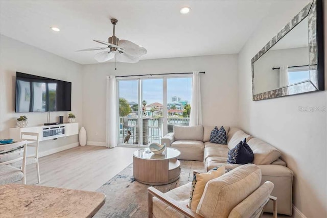 living room featuring ceiling fan and wood-type flooring