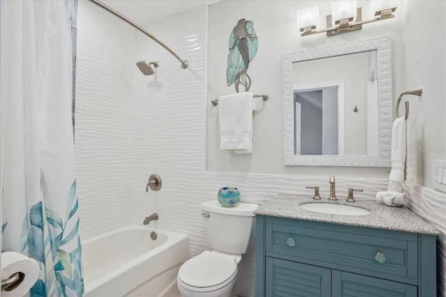 full bathroom featuring toilet, vanity, and shower / bathtub combination with curtain