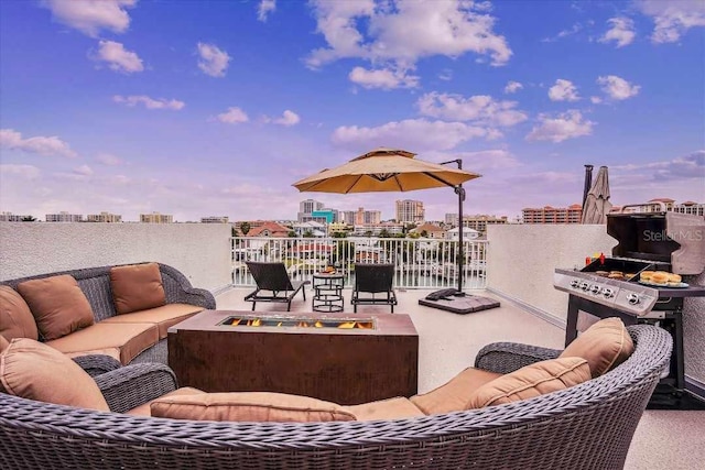 patio terrace at dusk with an outdoor living space with a fire pit