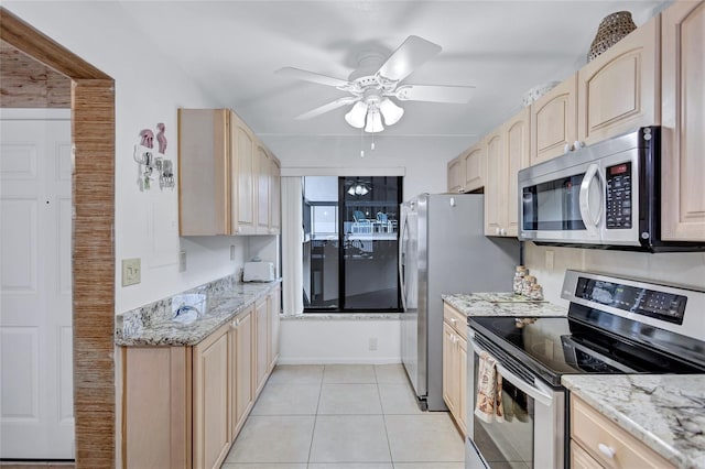 kitchen with light stone countertops, appliances with stainless steel finishes, and light brown cabinets