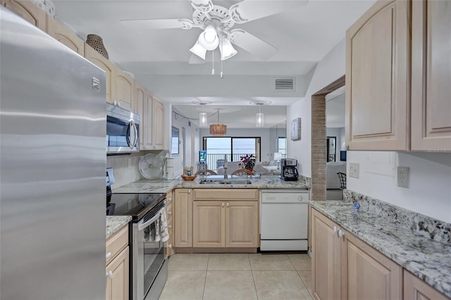 kitchen with light tile patterned flooring, sink, light brown cabinets, stainless steel appliances, and backsplash