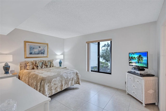 tiled bedroom featuring a textured ceiling