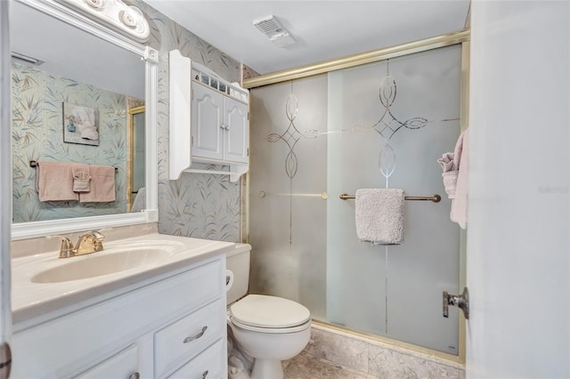 bathroom featuring vanity, an enclosed shower, and toilet