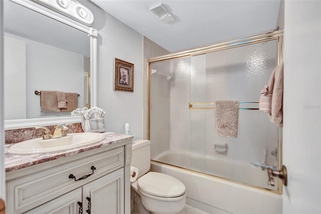 full bathroom with vanity, toilet, and combined bath / shower with glass door