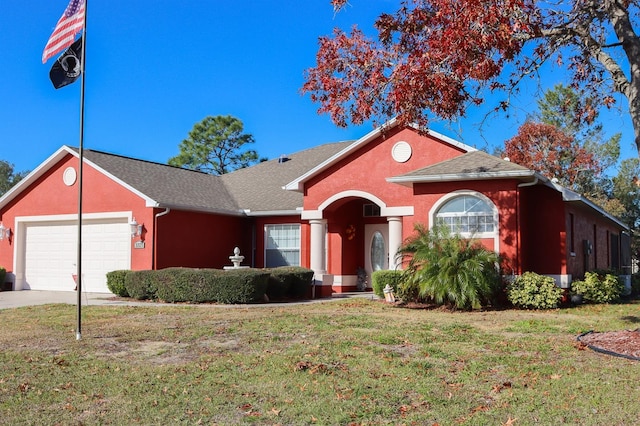 ranch-style home featuring a front yard and a garage