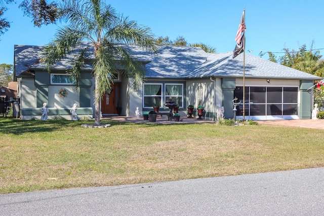 view of front facade featuring a front lawn and a sunroom