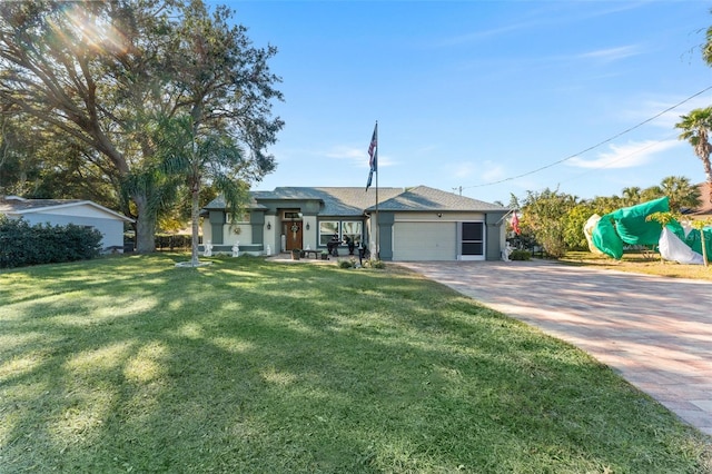 ranch-style house featuring a garage and a front yard