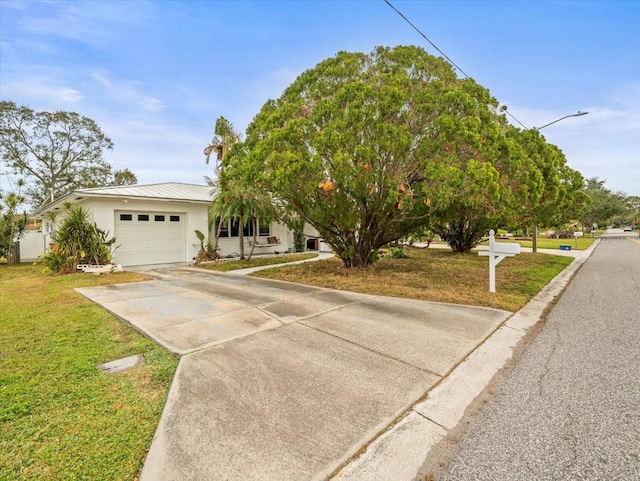 view of front of house featuring a garage and a front lawn