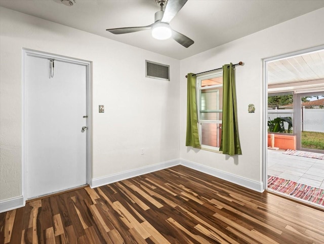 foyer with dark hardwood / wood-style floors and ceiling fan