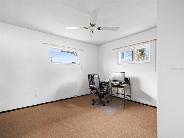 office area with ceiling fan, plenty of natural light, and carpet