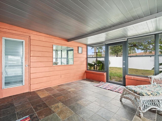 unfurnished sunroom with wooden ceiling and beam ceiling