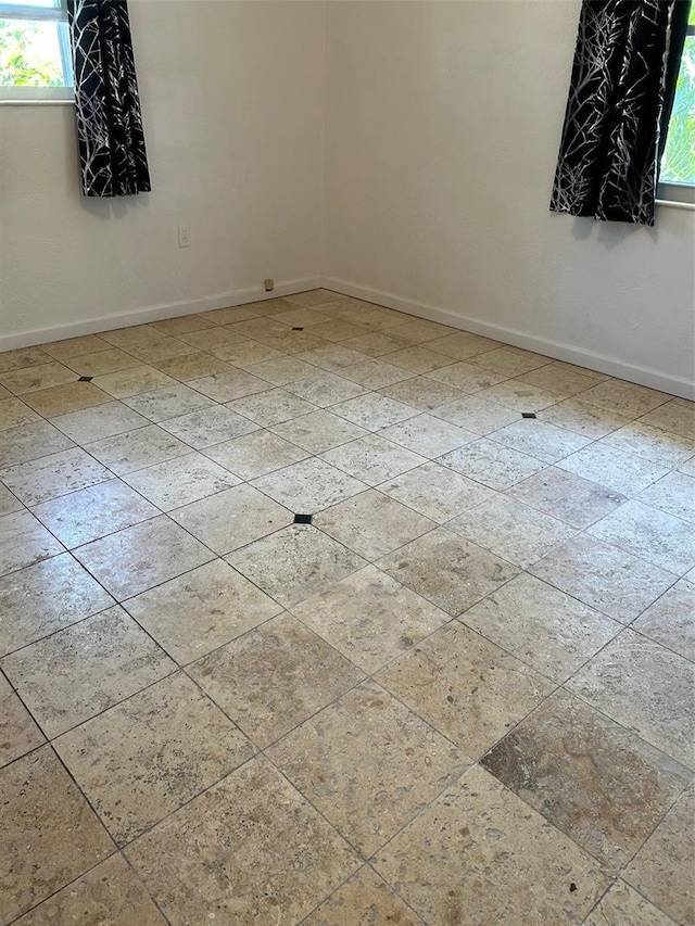 empty room featuring baseboards