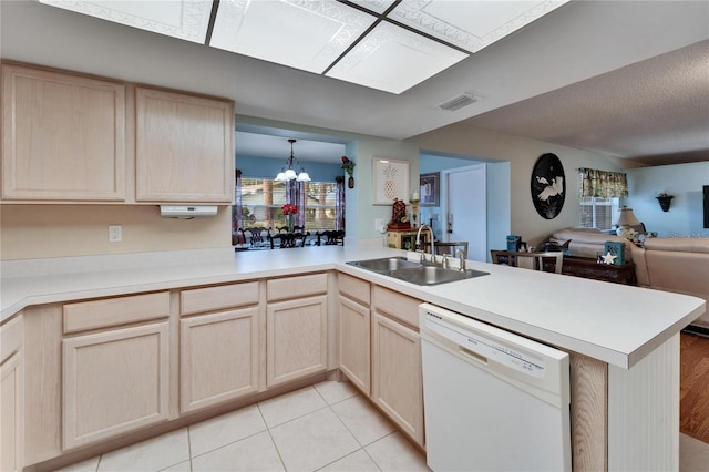 kitchen with dishwasher, an inviting chandelier, sink, kitchen peninsula, and light tile patterned flooring