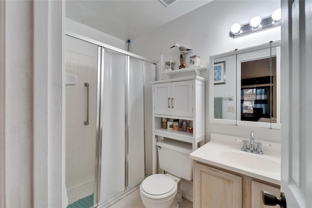 bathroom featuring vanity, toilet, and an enclosed shower