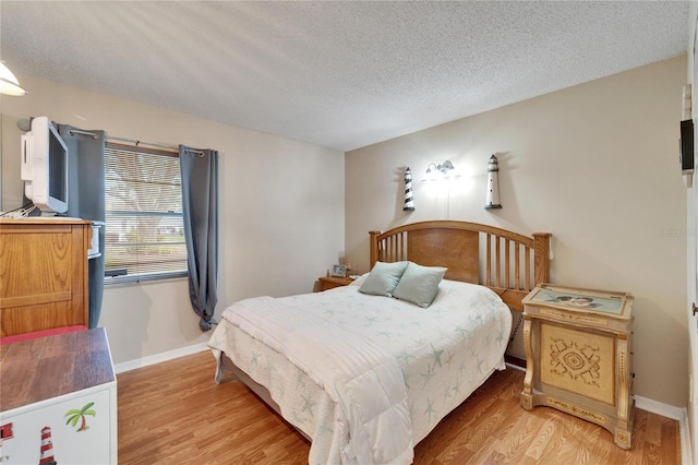 bedroom featuring a textured ceiling and wood-type flooring