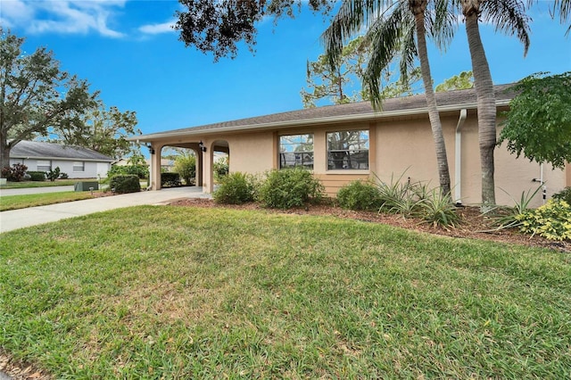 ranch-style house with a front lawn and a carport