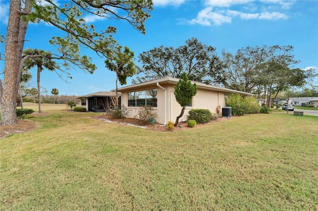 view of home's exterior featuring cooling unit and a lawn