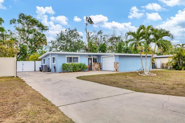 ranch-style home with a front lawn, central AC, and a garage