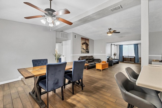 dining space featuring ceiling fan and beam ceiling