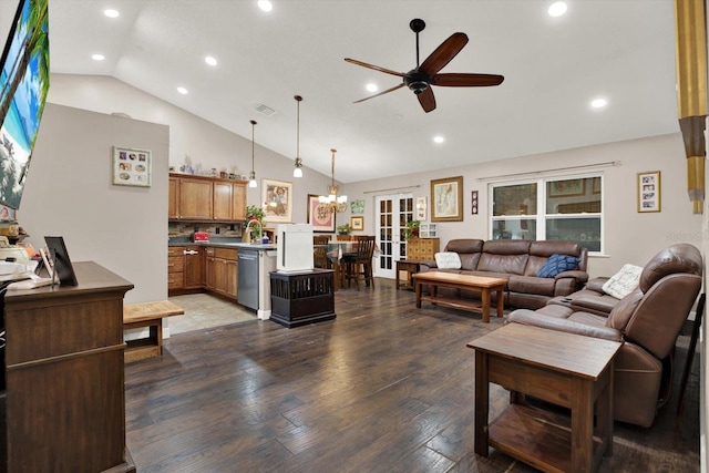 living room with dark hardwood / wood-style flooring, sink, ceiling fan with notable chandelier, and high vaulted ceiling