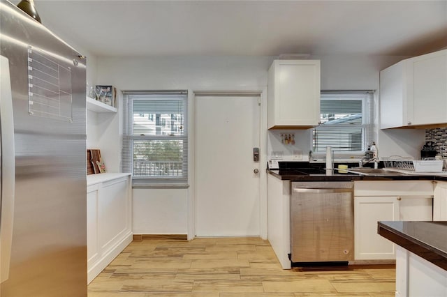 kitchen featuring dishwasher, white cabinets, and light wood-type flooring