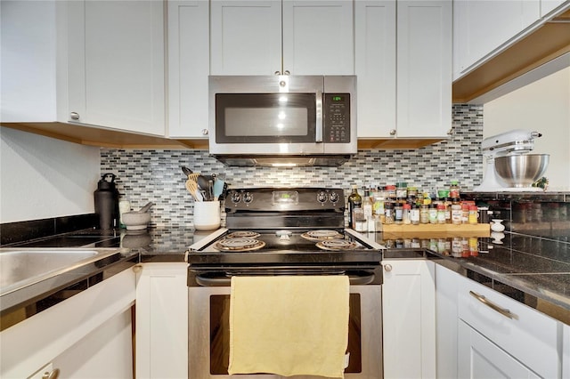 kitchen with white cabinetry, tasteful backsplash, and stainless steel appliances