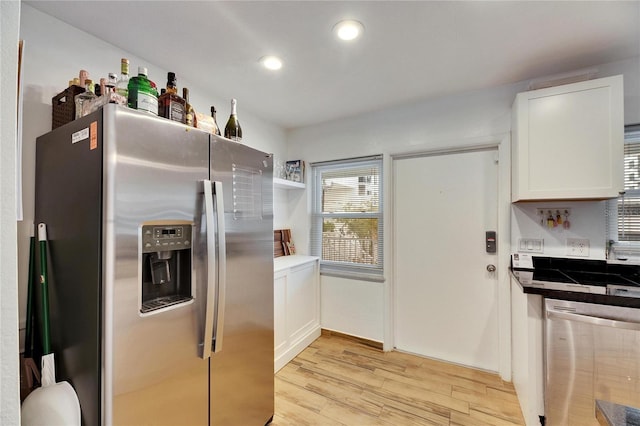 kitchen with stainless steel appliances, light wood-type flooring, and white cabinets