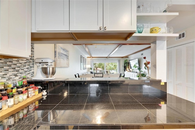 kitchen featuring white cabinetry and decorative backsplash