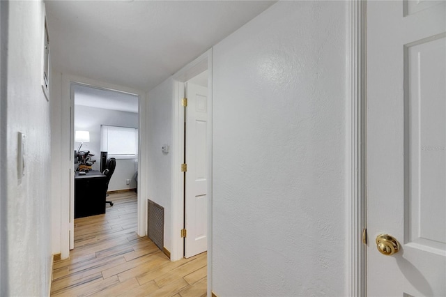 hall with light hardwood / wood-style floors