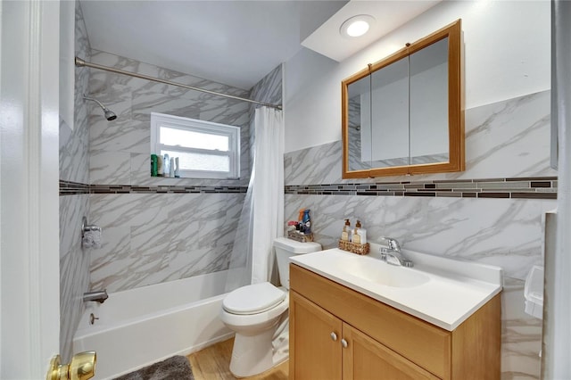 full bathroom featuring tile walls, vanity, toilet, and shower / bath combo with shower curtain