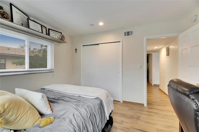 bedroom featuring light hardwood / wood-style flooring and a closet