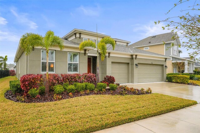 view of front of home with a garage and a front lawn