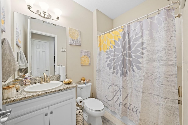 bathroom featuring vanity, a shower with shower curtain, and toilet